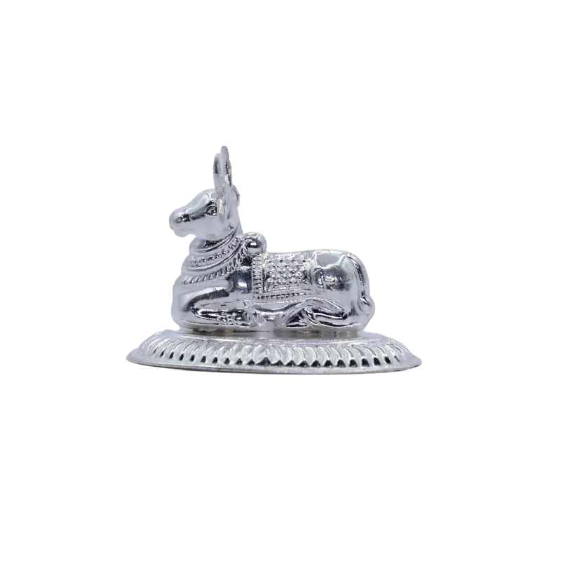 Reclining silver Nandi bull idol on an engraved base